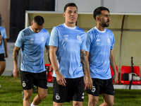 Andres Villa (C) and Ali Asadalla Thaimn (R) of Al Sadd FC look on before the training session at Jassim Bin Hamad Stadium in Doha, Qatar, o...