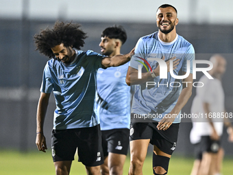 Akram Hassan Afif (L) and Romain Saiss (R) of Al Sadd FC participate in the training session at Jassim Bin Hamad Stadium in Doha, Qatar, on...