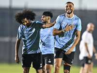 Akram Hassan Afif (L) and Romain Saiss (R) of Al Sadd FC participate in the training session at Jassim Bin Hamad Stadium in Doha, Qatar, on...