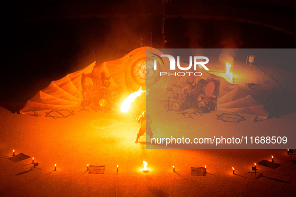 A Zoolians artist captivates the audience with a fiery performance during the closing show of '????????'?????: Arcanes' in the Arles arenas....