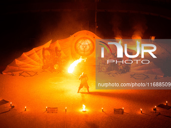 A Zoolians artist captivates the audience with a fiery performance during the closing show of '????????'?????: Arcanes' in the Arles arenas....