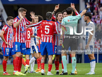 Players of Atletico de Madrid (from left to right) Alexander Sorloth, Rodrigo De Paul, and Antoine Griezmann argue with the referee during t...