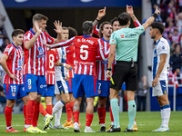 Players of Atletico de Madrid (from left to right) Alexander Sorloth, Rodrigo De Paul, and Antoine Griezmann argue with the referee during t...