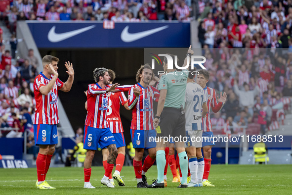 Players of Atletico de Madrid (from left to right) Alexander Sorloth, Rodrigo De Paul, and Antoine Griezmann argue with the referee during t...