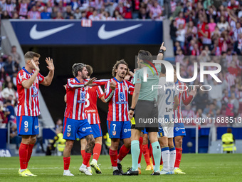 Players of Atletico de Madrid (from left to right) Alexander Sorloth, Rodrigo De Paul, and Antoine Griezmann argue with the referee during t...