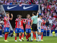 Players of Atletico de Madrid (from left to right) Alexander Sorloth, Rodrigo De Paul, and Antoine Griezmann argue with the referee during t...