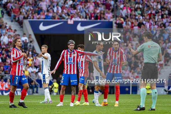 Players of Atletico de Madrid (from left to right) Antoine Griezmann, Rodrigo De Paul, and Jose Gimenez argue with the referee during the La...