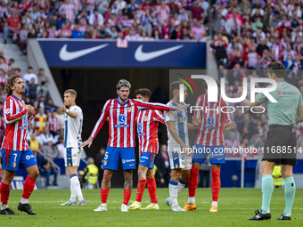 Players of Atletico de Madrid (from left to right) Antoine Griezmann, Rodrigo De Paul, and Jose Gimenez argue with the referee during the La...