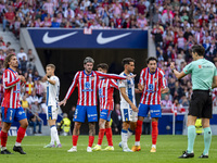 Players of Atletico de Madrid (from left to right) Antoine Griezmann, Rodrigo De Paul, and Jose Gimenez argue with the referee during the La...