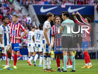 Antoine Griezmann of Atletico de Madrid argues with the referee during the La Liga EA Sports 2024/25 football match between Atletico de Madr...