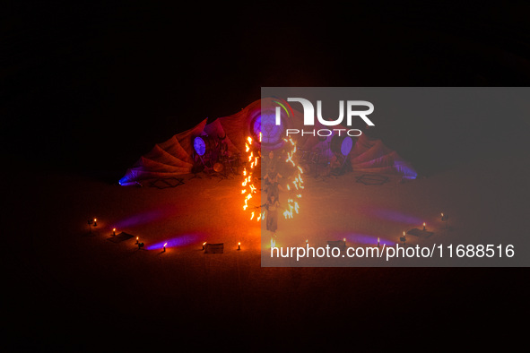 A Zoolians artist captivates the audience with a fiery performance during the closing show of '????????'?????: Arcanes' in the Arles arenas....