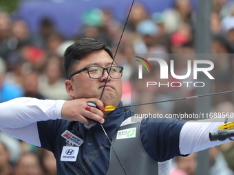 Kim Woojin of Korea competes against Lee Woo Seok of Korea (not in picture) during the Men's recurve final match on the final day of the Tla...