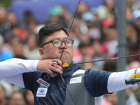 Kim Woojin of Korea competes against Lee Woo Seok of Korea (not in picture) during the Men's recurve final match on the final day of the Tla...