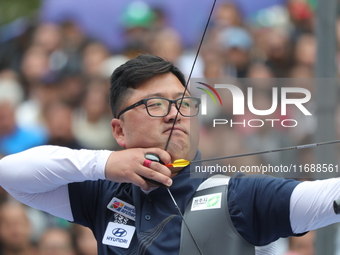 Kim Woojin of Korea competes against Lee Woo Seok of Korea (not in picture) during the Men's recurve final match on the final day of the Tla...