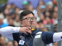 Kim Woojin of Korea competes against Lee Woo Seok of Korea (not in picture) during the Men's recurve final match on the final day of the Tla...