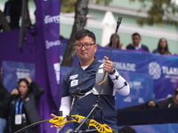 Kim Woojin of Korea competes against Lee Woo Seok of Korea (not in picture) during the Men's recurve final match on the final day of the Tla...