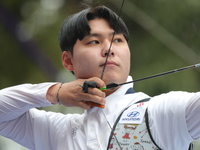 Lee Woo Seok of Korea competes against Kim Woojin of Korea (not in picture) during the Men's recurve final match on the final day of the Tla...