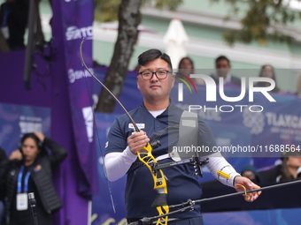 Kim Woojin of Korea competes against Lee Woo Seok of Korea (not in picture) during the Men's recurve final match on the final day of the Tla...