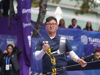 Kim Woojin of Korea competes against Lee Woo Seok of Korea (not in picture) during the Men's recurve final match on the final day of the Tla...