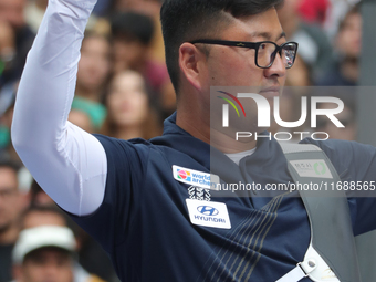 Kim Woojin of Korea competes against Lee Woo Seok of Korea (not in picture) during the Men's recurve final match on the final day of the Tla...