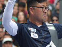 Kim Woojin of Korea competes against Lee Woo Seok of Korea (not in picture) during the Men's recurve final match on the final day of the Tla...