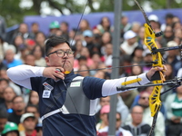 Kim Woojin of Korea competes against Lee Woo Seok of Korea (not in picture) during the Men's recurve final match on the final day of the Tla...