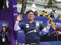 Kim Woojin of Korea competes against Lee Woo Seok of Korea (not in picture) during the Men's recurve final match on the final day of the Tla...