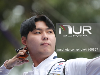 Lee Woo Seok of Korea competes against Kim Woojin of Korea (not in picture) during the Men's recurve final match on the final day of the Tla...