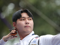 Lee Woo Seok of Korea competes against Kim Woojin of Korea (not in picture) during the Men's recurve final match on the final day of the Tla...