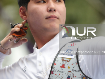 Lee Woo Seok of Korea competes against Kim Woojin of Korea (not in picture) during the Men's recurve final match on the final day of the Tla...