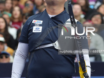 Kim Woojin of Korea competes against Lee Woo Seok of Korea (not in picture) during the Men's recurve final match on the final day of the Tla...