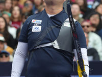 Kim Woojin of Korea competes against Lee Woo Seok of Korea (not in picture) during the Men's recurve final match on the final day of the Tla...