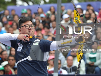 Kim Woojin of Korea competes against Lee Woo Seok of Korea (not in picture) during the Men's recurve final match on the final day of the Tla...