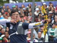 Kim Woojin of Korea competes against Lee Woo Seok of Korea (not in picture) during the Men's recurve final match on the final day of the Tla...