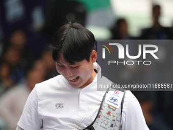 Lee Woo Seok of Korea competes against Kim Woojin of Korea (not in picture) during the Men's recurve final match on the final day of the Tla...