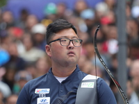 Kim Woojin of Korea competes against Lee Woo Seok of Korea (not in picture) during the Men's recurve final match on the final day of the Tla...