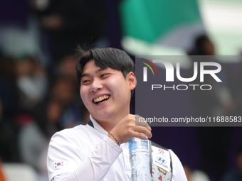 Lee Woo Seok of Korea competes against Kim Woojin of Korea (not in picture) during the Men's recurve final match on the final day of the Tla...