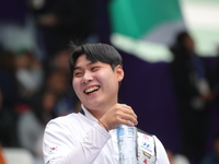 Lee Woo Seok of Korea competes against Kim Woojin of Korea (not in picture) during the Men's recurve final match on the final day of the Tla...