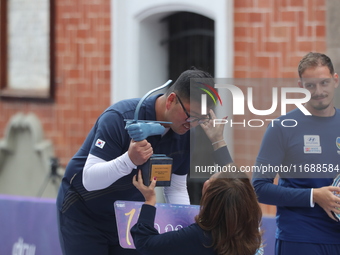 Gold medalist winner Kim Woojin of Korea receives the first place prize during the medal ceremony on the final day of the Tlaxcala 2024 Arch...