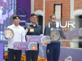 (Left to right) Silver medalist Lee Woo Seok of Korea, gold medalist Kim Woojin of Korea, and bronze medalist Marcus D'Almeida of Brazil sta...