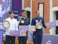 (Left to right) Silver medalist Lee Woo Seok of Korea, gold medalist Kim Woojin of Korea, and bronze medalist Marcus D'Almeida of Brazil sta...