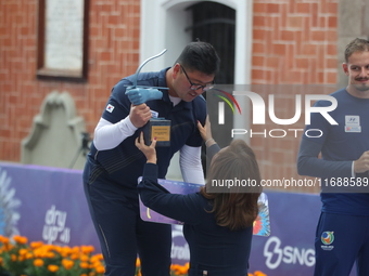 Gold medalist Kim Woojin of Korea receives the first place prize during the medal ceremony on the final day of the Tlaxcala 2024 Archery Wor...