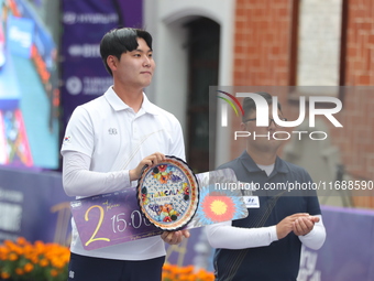 Gold medalist Kim Woojin of Korea and silver medalist Lee Woo Seok of Korea participate in the medal ceremony on the final day of the Tlaxca...