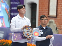 Gold medalist Kim Woojin of Korea and silver medalist Lee Woo Seok of Korea participate in the medal ceremony on the final day of the Tlaxca...