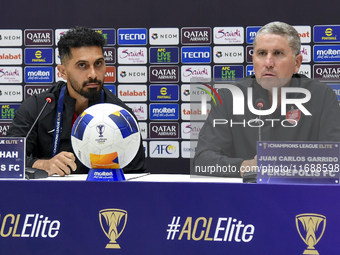 Head Coach of Persepolis FC Juan Carlos Fernandez (R) and player Omid Alishah (L) attend the press conference at Jassim Bin Hamad Stadium in...