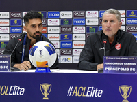 Head Coach of Persepolis FC Juan Carlos Fernandez (R) and player Omid Alishah (L) attend the press conference at Jassim Bin Hamad Stadium in...