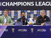 Head Coach of Persepolis FC Juan Carlos Fernandez (R) and player Omid Alishah (C) attend the press conference at Jassim Bin Hamad Stadium in...