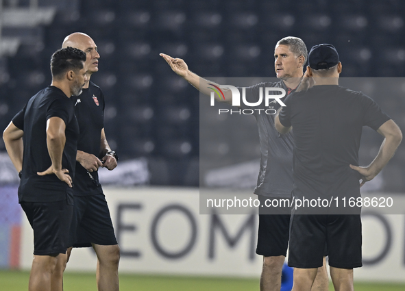 Head coach of Persepolis FC, Juan Carlos Fernandez (2nd R), participates in a training session at Jassim Bin Hamad Stadium in Doha, Qatar, o...