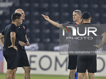 Head coach of Persepolis FC, Juan Carlos Fernandez (2nd R), participates in a training session at Jassim Bin Hamad Stadium in Doha, Qatar, o...