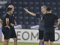 Head coach of Persepolis FC, Juan Carlos Fernandez (2nd R), participates in a training session at Jassim Bin Hamad Stadium in Doha, Qatar, o...